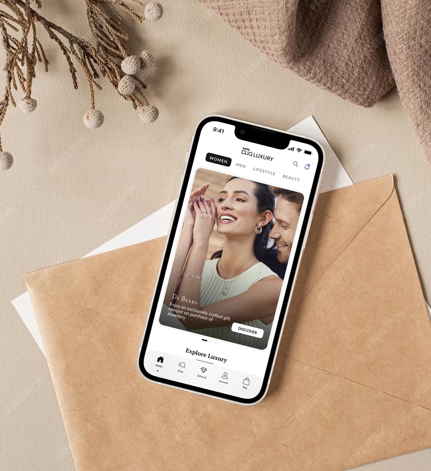 The redesigned Tata CLiQ Luxury app homepage on a phone